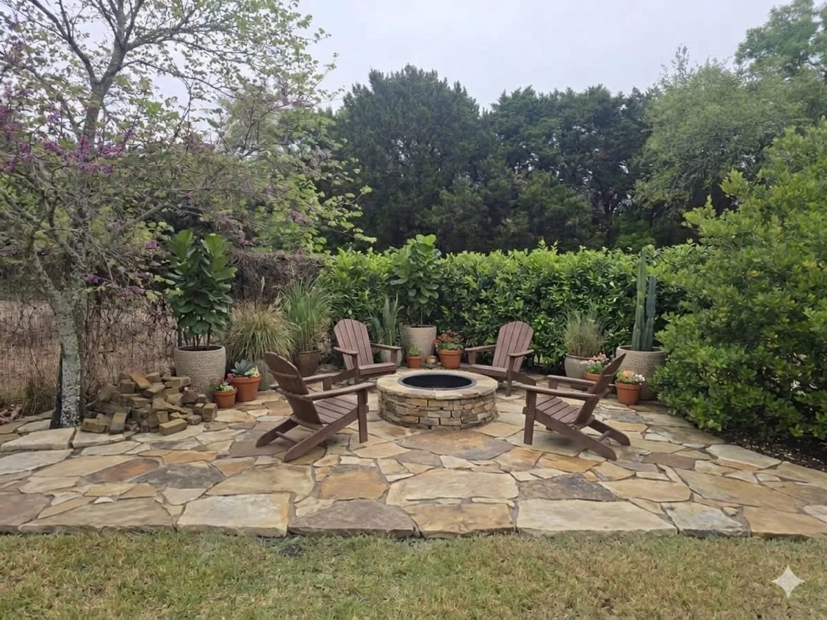 Completed circular flagstone fire pit patio with outdoor chairs and layered greenery