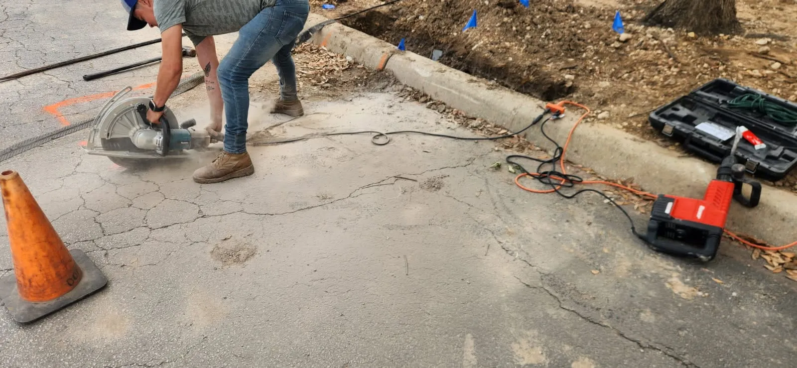 Crew preparing an existing concrete walkway for a hardscape renovation