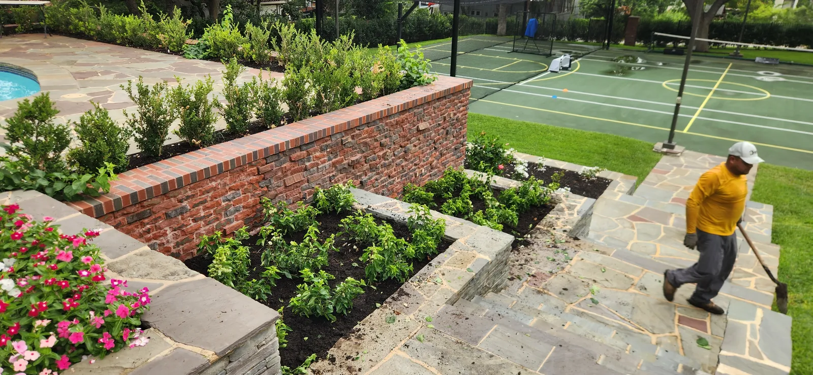 Structured garden beds with brick borders and layered planting