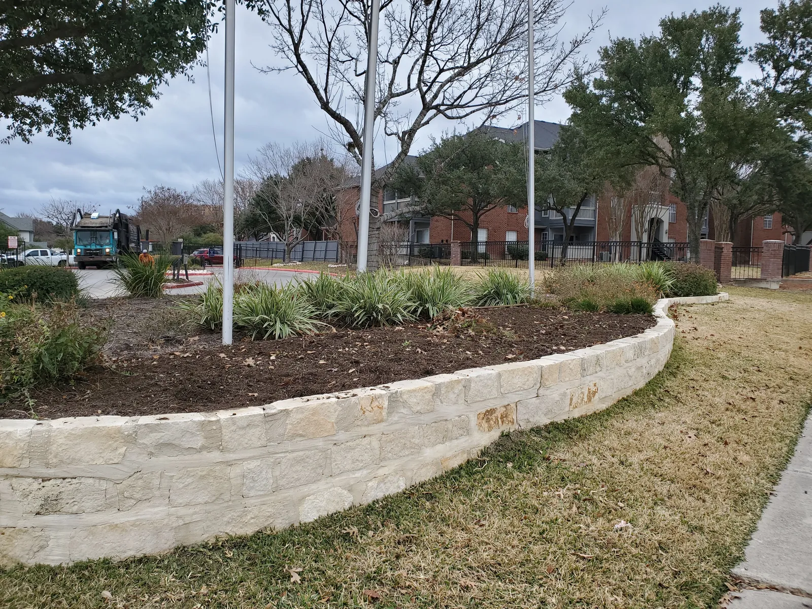 Raised stone landscape bed at a residential property